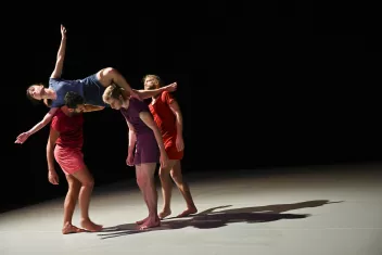 photo d'un spectacle avec 3 danseurs qui porte une danseuse