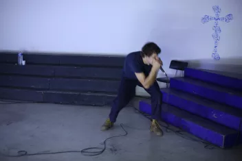 a photo of the singer Aymeric Hainaux looking towards the blue-painted stands 