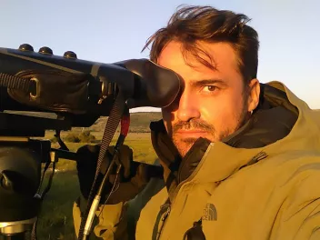 Photo of Baptiste Morizot behind a camera
