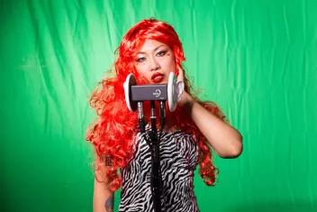 a photograph of the artist Betty Apple with a sound installation in front of her