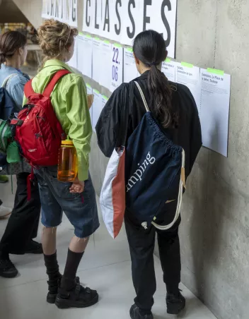 Photos of dancers looking at the class timetable 