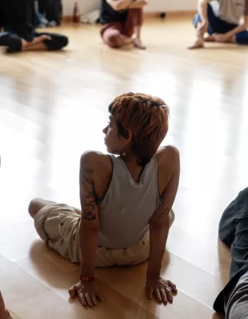 photo of a workshop with dancers sitting in a circle