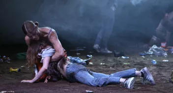 A photo from Patric Chiha’s film "Si c’était de l’amour", showing two dancers on a floor covered in earth