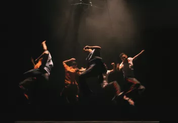 a photo of a performance by Mourad Merzouki featuring dancers jumping