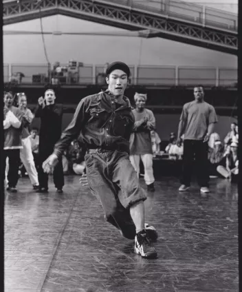 Black-and-white photograph of a breakdancing demonstration