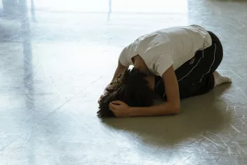 photo of a dancer kneeling on the floor