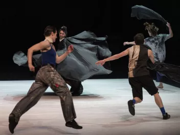 a photo of a performance featuring four dancers running in a circle