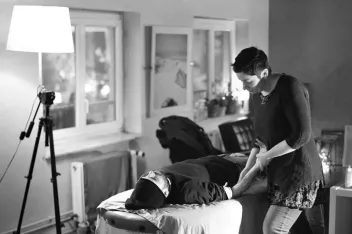 black-and-white photo of a person giving a massage 