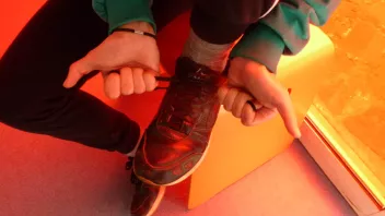 Close-up of a person lacing up their trainers