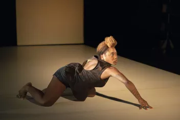 photo of a dancer kneeling on the floor