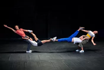 Four dancers perform lifts facing each other 