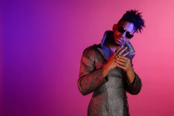 Photo by KillASon, alias Marcus Dossavi-Gourdot, against a purple-pink gradient background