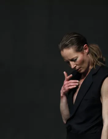 a side-profile photo of Brit Rodemund dressed in black